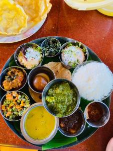 a plate with different types of food on a table at La Maison Pondichéry in Pondicherry
