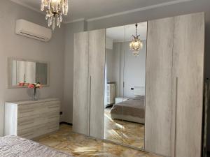 a bedroom with a mirrored closet with a mirror at SUNNY APARTMENT with big terrace in Rapallo