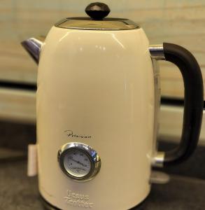 a tea kettle with a clock on top of it at Apart Hotel Rapa Nui in Hanga Roa