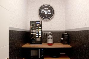 a coffee shop with a coffee machine on a counter at Woohoo Rooms Hortaleza in Madrid
