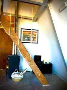 a wooden staircase in a room with a sink at Cabaña Nórdica muy cómoda para unos días de relax in Villa Serrana