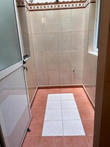 a bathroom with a shower with a tiled floor at 2 Zimmer Wohnung Corniche Nador Sidi Ali- am Meer & Wifi in Nador