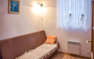 a couch sitting in a room with a window at Pet Friendly Home In Sokole Kuznica With Kitchen in Sokole-Kuźnica