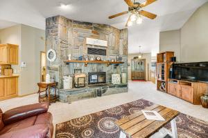 a living room with a large stone fireplace at Crooked Canyon Lodge in Rapid City