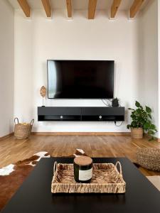 a living room with a large flat screen tv at Holiday house DOMa Nová Lesná in Nová Lesná