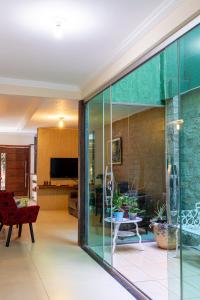 a living room with glass doors and a living room at Pousada Jardim Brasília in Brasilia