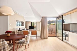 a kitchen and living room with a table and chairs at 108MM House in Porto
