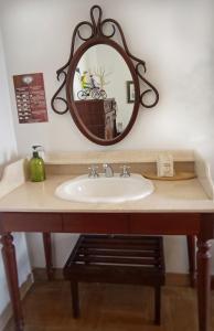 a bathroom sink with a mirror on the wall at Hotel Don Alfonso in Pereira