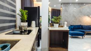 a kitchen with a sink and a living room at Green Line Long Bien - Serviced Apartment - Ngoc Thuy - Hanoi in Hanoi