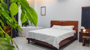 a bedroom with a bed and a bath tub at Green Line Long Bien - Serviced Apartment - Ngoc Thuy - Hanoi in Hanoi