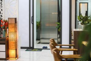 a pair of chairs sitting in front of a door at Green Line Long Bien - Serviced Apartment - Ngoc Thuy - Hanoi in Hanoi