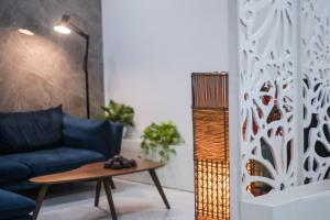 a living room with a blue couch and a table at Green Line Long Bien - Serviced Apartment - Ngoc Thuy - Hanoi in Hanoi