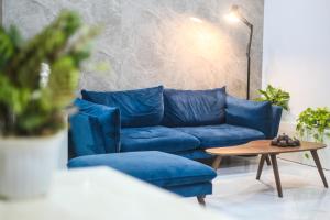 a blue couch and a coffee table in a living room at Green Line Long Bien - Serviced Apartment - Ngoc Thuy - Hanoi in Hanoi
