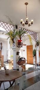 a living room with a table and chairs and a chandelier at Hotel Don Alfonso in Pereira