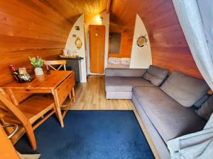 a living room with a couch and a table at The Golden Ball Luxury Pods in Morecambe