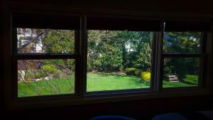 two windows in a room with a view of a yard at HA Whitney Inn in Columbus