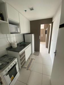 a small kitchen with a stove and a microwave at Smart Residence flat 505 in Teresina +7 photos