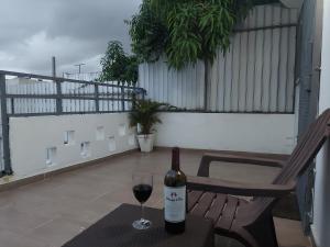 a bottle of wine sitting on a table with a glass at Casa Kamanda, Zona Colonial, Santo Domingo in Santo Domingo