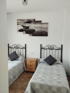 two beds sitting next to each other in a bedroom at Nuevo Jerez in Jerez de la Frontera