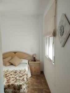 a bedroom with a bed and a window at Nuevo Jerez in Jerez de la Frontera