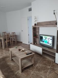 a living room with a tv and a coffee table at Nuevo Jerez in Jerez de la Frontera