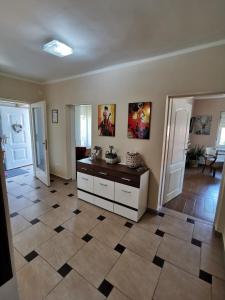 a living room with a tile floor and a counter at KUĆA VILA IDILA VRŠAC in Vršac