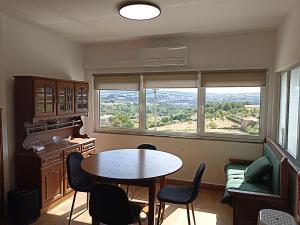 a dining room with a table and chairs and a window at Casa Machado in Vila Real