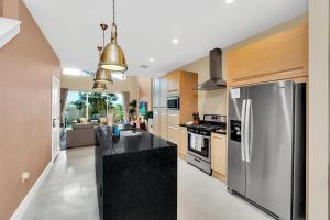 a kitchen with a stainless steel refrigerator at Luxury Villa Less Than A Mile From Disneyworld -Bonus Elevator- in Orlando