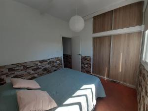 a bedroom with a blue bed and wooden cabinets at Vv Puerto del Trigo - Stella in Alojera