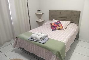 a bedroom with a bed with towels on it at Harmonia Haus in Blumenau