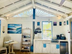 a kitchen with a sink and a stove in a room at Huatulco Beach Casita surf-river-national park in Santa Cruz Huatulco