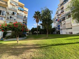 a park in front of some apartment buildings at Apartamento con piscina y barbacoa in Cala del Moral