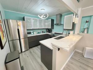 a kitchen with stainless steel appliances and blue walls at Private Luxury Retreat with Kitchen Near SF & Wine Country in San Rafael +44 photos