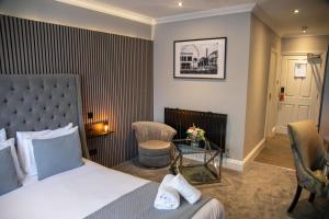 a hotel room with a bed and a table and chairs at Best Western Gables Hotel in Falfield