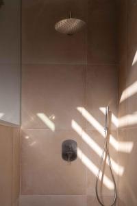 a shower with a shower head and a light fixture at BASÂLTO Casas Rurales in Hermigua