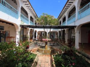 a courtyard of a building with a fountain at HOTEL AQUA VITAE in Villa de Leyva