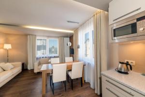 a kitchen and living room with a table and a couch at Apartament Marina in Jastarnia