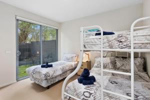 a bedroom with two bunk beds and a window at OG- By the Sea, 400m to Beach in Ocean Grove