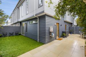 a house with a lawn in front of it at OG- By the Sea, 400m to Beach in Ocean Grove