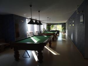 a row of pool tables in a room with lights at Ośrodek Wypoczynkowy "Hotel Korona" in Mostowice