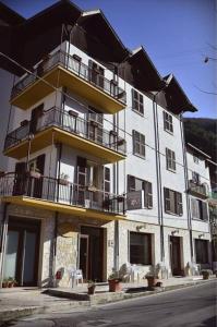 a large white building with balconies on a street at Hotel Margherita in Scanno