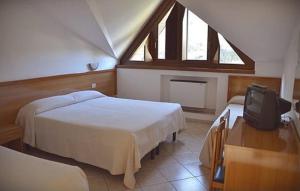 Postel nebo postele na pokoji v ubytování Hotel Margherita