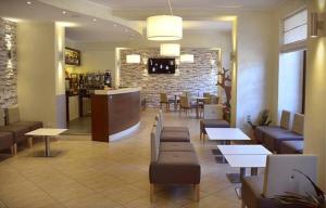 a restaurant with tables and chairs and a bar at Hotel Margherita in Scanno