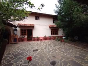 a house with a stone patio in front of it at LA CASA DE DOÑA EMMA in Mazamitla