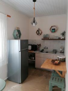 a kitchen with a stainless steel refrigerator and a wooden table at Vicky's Panoramic View Apartments in Pelekas