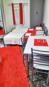 a room with four beds and red carpet at Studio Laura in Split