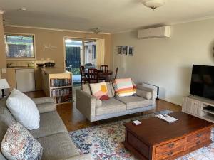 a living room with a couch and a coffee table at Perfect on Pymble Ave in Inverloch