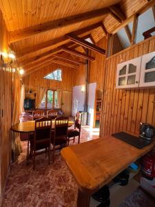 a dining room with a table and chairs at Cabañas Bosque las Trancas in Las Trancas