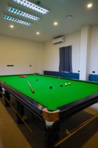 a room with a pool table with balls on it at Double J Hotel in Chiang Mai