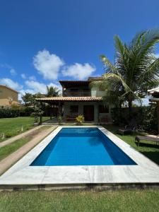 a swimming pool in front of a house at Casa em Peroba/Maragogi in Maragogi